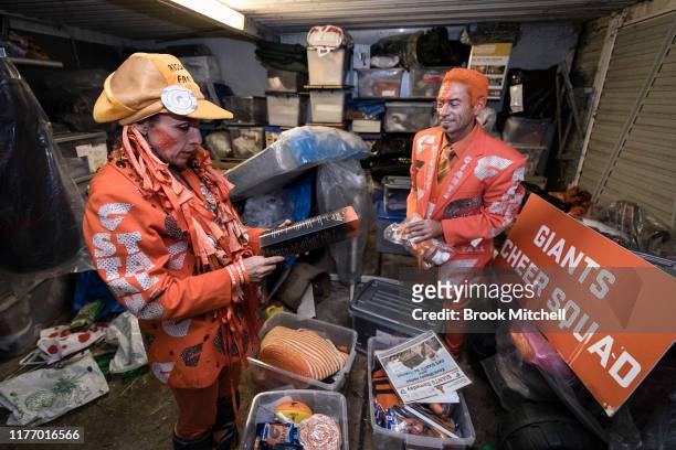 Giants fans Kath and Seb Dell'Orefice dig through mountains of Giants memorabilia in their garage before Saturday's 2019 AFL Grand Final on September...