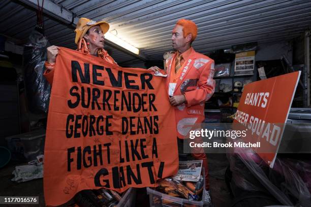 Giants fans Kath and Seb Dell'Orefice dig through mountains of Giants memorabilia in their garage before Saturday's 2019 AFL Grand Final on September...