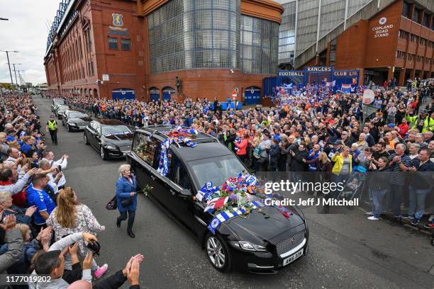 Fans pay their respects to former Rangers player Fernando Ricksen as his funeral cortege makes its way past Ibrox Stadium, along Paisley Road West on...