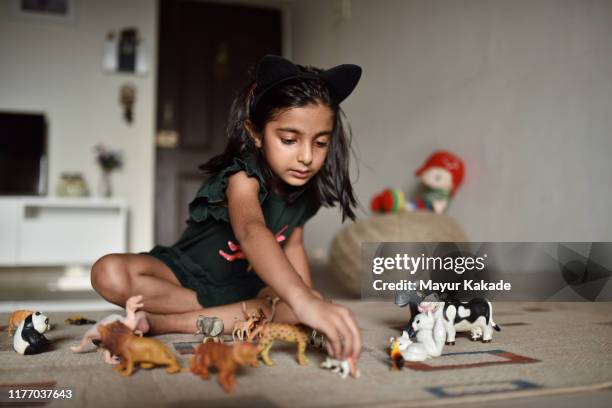 girl (4-5 years) playing animal toys - toy animal stock pictures, royalty-free photos & images