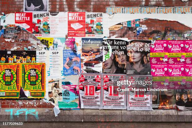 wall covered in posters - poster wall stock pictures, royalty-free photos & images