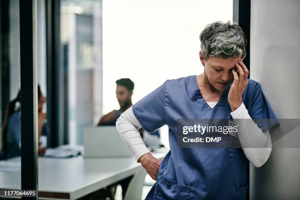 my job can be so stressful at times - sad nurse stock pictures, royalty-free photos & images