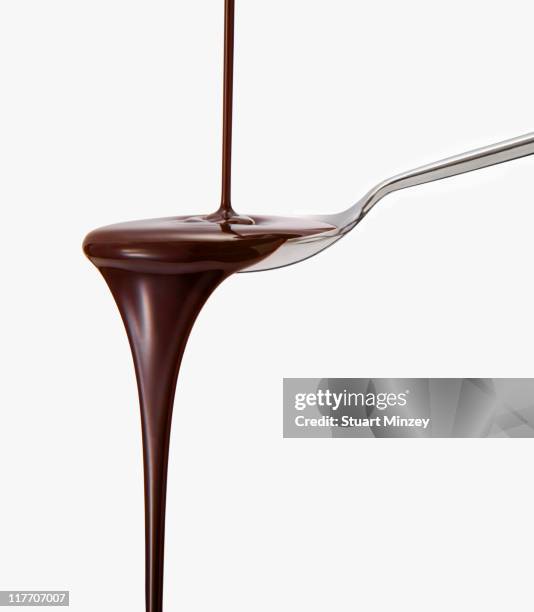 chocolate sauce dripping from spoon - chocolate sauce stock pictures, royalty-free photos & images