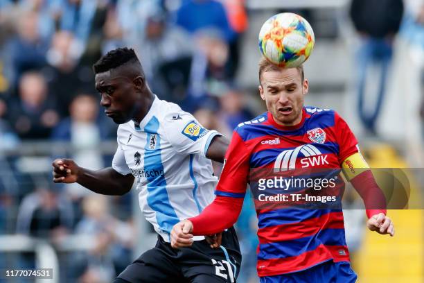 Prince Osei Owusu of TSV 1860 Muenchen and Jan Kirchhoff of KFC Uerdingen battle for the ball during the 3. Liga match between TSV 1860 Muenchen and...