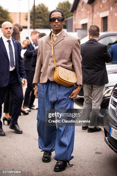 Rocky, wearing brown blazer, blue jeans, Gucci bag and Gucci shoes, is seen outside the Gucci show during Milan Fashion Week Spring/Summer 2020 on...