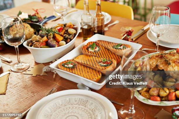 meal with wine served on dining table at home - portion imagens e fotografias de stock