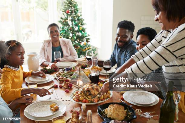 woman cutting meat for family and friends on table - christmas table turkey ストックフォトと画像