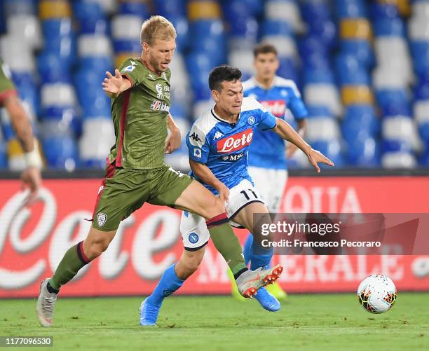 Hirving Lozano of SSC Napoli vies with Ragnar Klavan of Cagliari Calcio during the Serie A match between SSC Napoli and Cagliari Calcio at Stadio San...