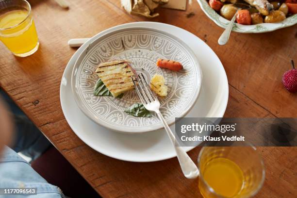 high angle view of leftovers in plate on table - leftovers stock pictures, royalty-free photos & images