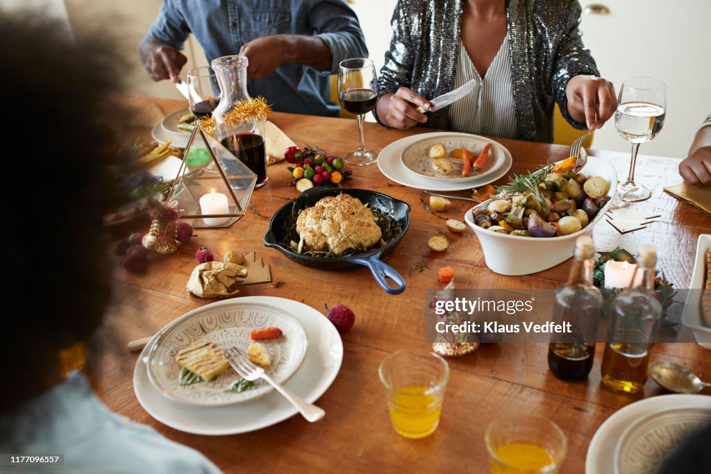 Midsection of couple having lunch on dining table