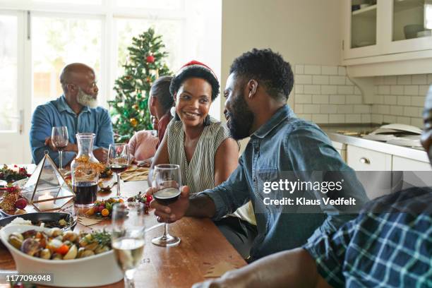 family and friends talking while enjoying at home - south africa wine stock pictures, royalty-free photos & images