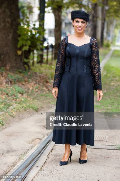 Agus Cattaneo, wearing a black midi dress, black hat and black heels, is seen outside the Dolce e Gabbana show during Milan Fashion Week...