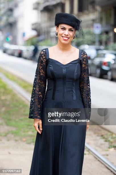 Agus Cattaneo, wearing a black midi dress and black hat, is seen outside the Dolce e Gabbana show during Milan Fashion Week Spring/Summer 2020 on...