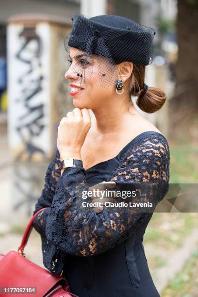 Agus Cattaneo, wearing a black midi dress and black hat, is seen outside the Dolce e Gabbana show during Milan Fashion Week Spring/Summer 2020 on...