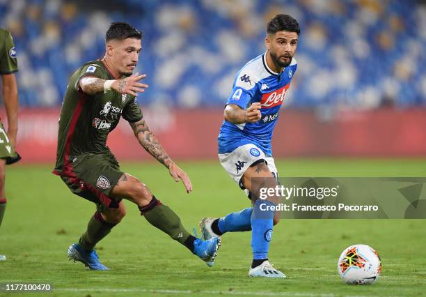 Lorenzo Insigne of SSC Napoli vies with Fabio Pisacane of Cagliari Calcio during the Serie A match between SSC Napoli and Cagliari Calcio at Stadio...