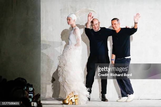 Christian Lacroix, Dries Van Noten and a model acknowledge the audience during the Dries Van Noten Womenswear Spring/Summer 2020 show at Opera...