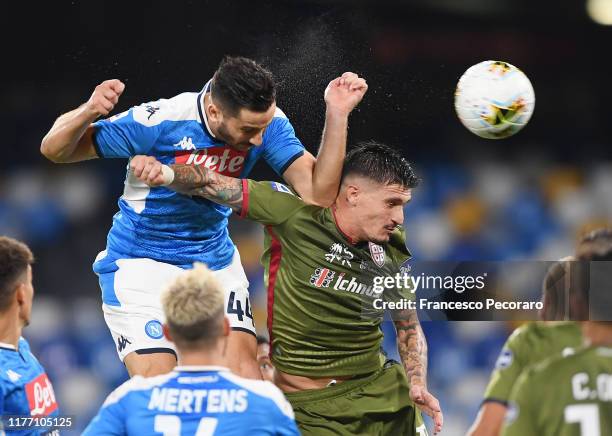 Kostantinos Manolas of SSC Napoli vies with Fabio Pisacane of Cagliari Calcio during the Serie A match between SSC Napoli and Cagliari Calcio at...