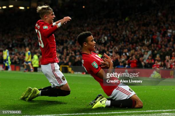 Mason Greenwood of Manchester United celebrates scoring his teams first goal of the game with team mate Brandon Williams during the Carabao Cup Third...