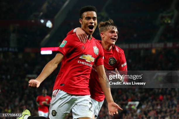 Mason Greenwood of Manchester United celebrates scoring his teams first goal of the game with team mate Brandon Williams during the Carabao Cup Third...