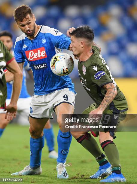 Fernando Llorente of SSC Napoli vies with Fabio Pisacane of Cagliari Calcio during the Serie A match between SSC Napoli and Cagliari Calcio at Stadio...