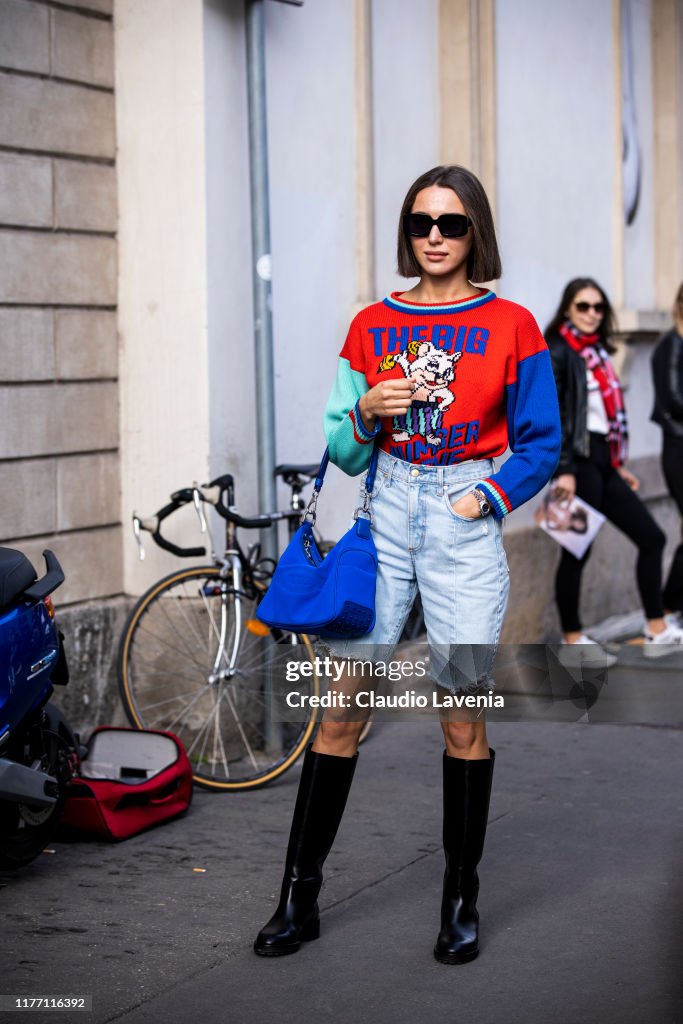 Mary Leest, wearing a printed jumper, denim shorts, black boots and ...