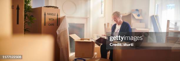 packing the family album - downsizing elderly stock pictures, royalty-free photos & images