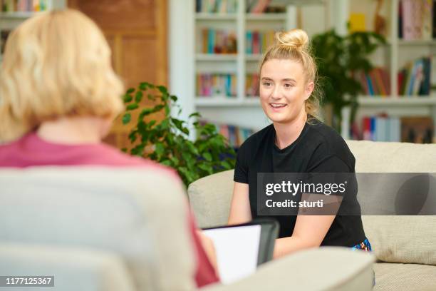 informal job interview - stressed young woman sitting on couch stock pictures, royalty-free photos & images