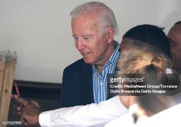 Presidential candidate Joe Biden takes a selfie with caterers as he leaves a private fundraiser at a home in Manhattan Beach on Wednesday, Sep. 25,...