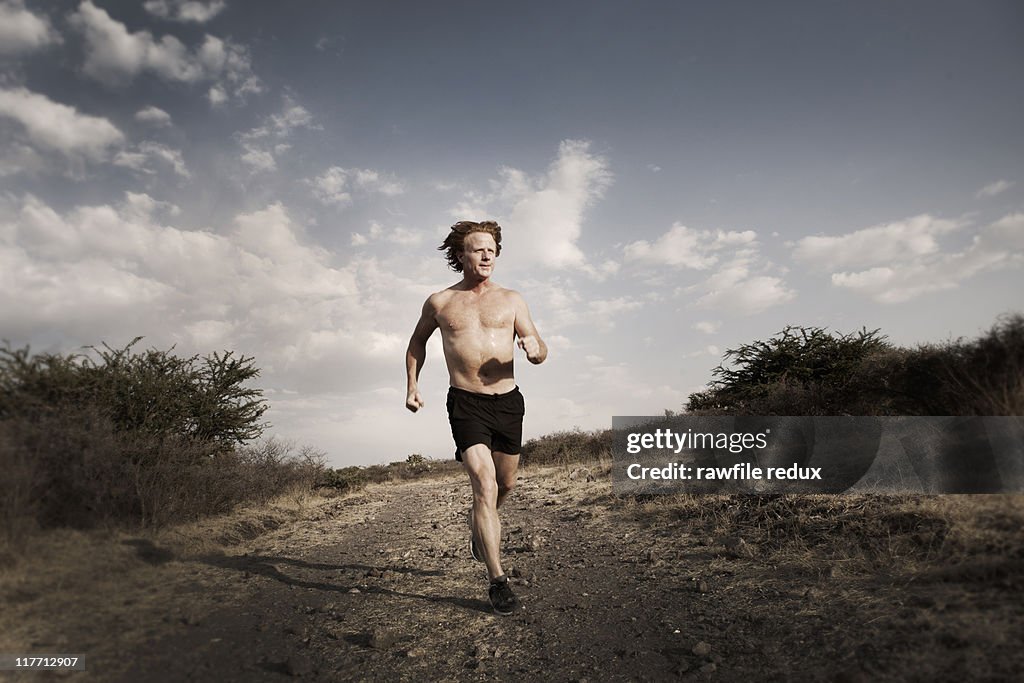 Man running on a road in the countryside