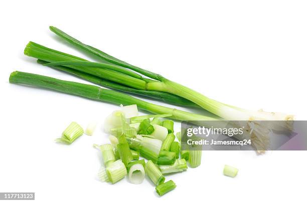 whole and chopped green onions isolated on white background - scallion stock pictures, royalty-free photos & images