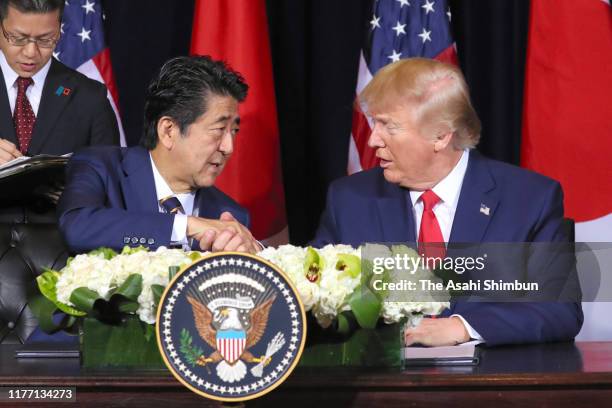 Japanese Prime Minister Shinzo Abe and U.S. President Donald Trump shake hands as they reach the trade agreement following their meeting on September...