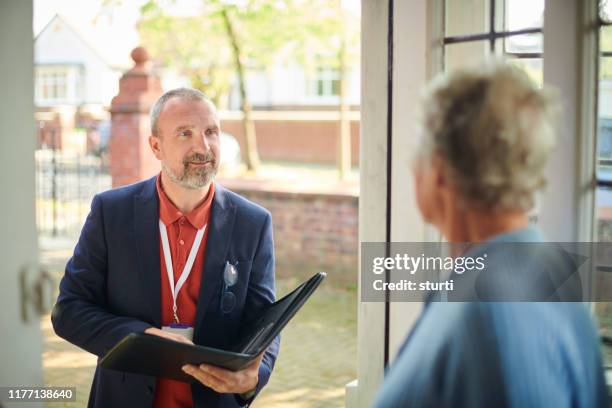 salesman knocking - door to door salesperson stock pictures, royalty-free photos & images