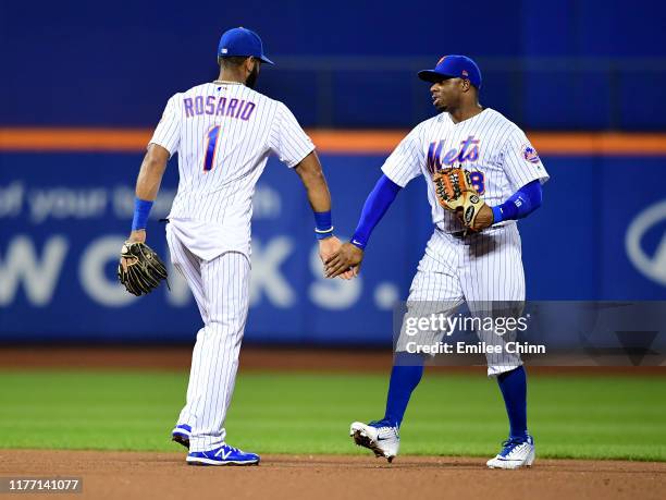 Rajai Davis and Amed Rosario of the New York Mets high five after their 10-3 win over the Miami Marlins at Citi Field on September 25, 2019 in the...