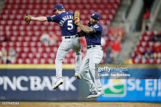 Eric Thames and Cory Spangenberg of the Milwaukee Brewers celebrate after clinching a playoff berth following a 9-2 win over the Cincinnati Reds at...