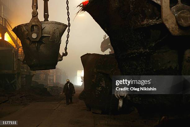 Metal flows throughout the day into furnaces in a copper plant July 19, 2002 in Norilsk, Russia. Workers must keep a watchful eye to prevent backups...