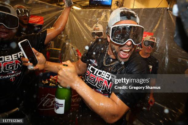 Nelson Cruz of the Minnesota Twins celebrates winning the American League Central Division title after a 5-1 win against the Detroit Tigers and a...