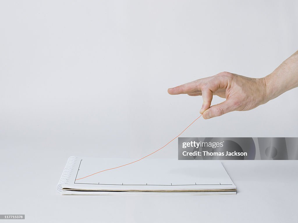 Hand elevating graph line off the page