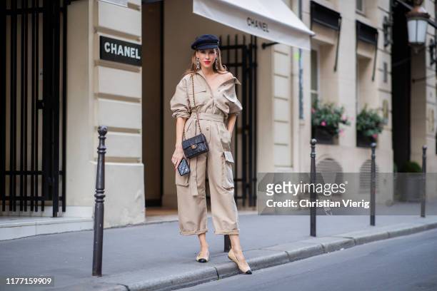 Alexandra Lapp is seen wearing a beige Frankie Shop jumpsuit, Chanel earrings, vintage Chanel classic bag, Chanel ballerinas, Chanel baker boy cap...