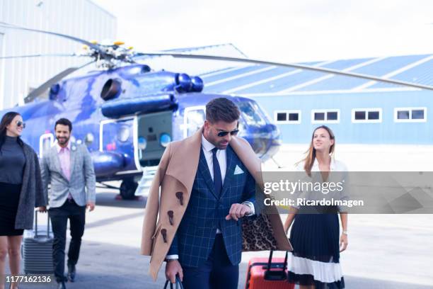 business people ready to travel by helicopter - billionaires stock pictures, royalty-free photos & images