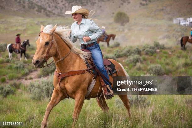 cowgirl horseback riding - riding boot imagens e fotografias de stock