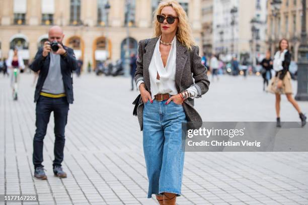 Elina Halimi is seen wearing denim jeans, brown boots, blazer outside Guy Laroche during Paris Fashion Week Womenswear Spring Summer 2020 on...