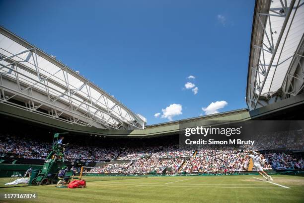 Roberto Bautista Agut of Spain serves during the Men's Singles Semi Final against Novak Djokovic of Serbia at The Wimbledon Lawn Tennis Championship...