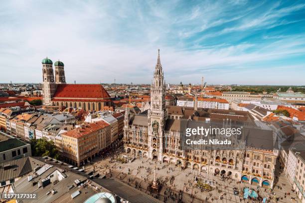 panorama of marienplatz square with new town hall and frauenkirche (cathedral of our lady). - munich stock pictures, royalty-free photos & images