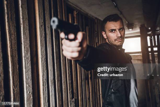 fbi agent on a mission - firing handgun stock pictures, royalty-free photos & images