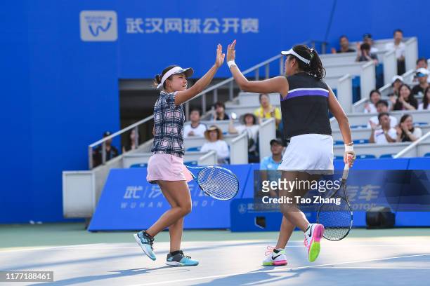 Zhaoxuan Yang of China and Makoto Ninomiya of Japan react during the match against Nicoloe Melichar of USA and her partner Kveta Peschke of Czech...
