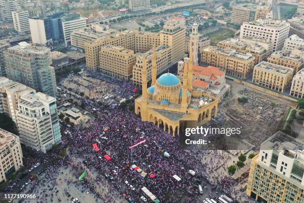 An aerial view taken on October 20 shows Lebanese protesters rallying outside the Mohammed al-Amin Mosque and the nearby Maronite Cathedral of St...