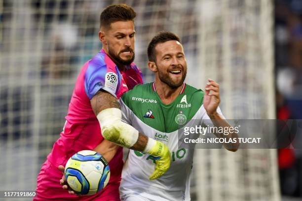 Saint-Etienne's French midfielder Yohan Cabaye celebrates after his team scored a penalty kick while Bordeaux's French goalkeeper Benoit Costil tries...