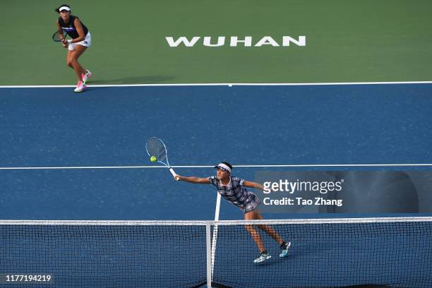 Zhaoxuan Yang of China and Makoto Ninomiya of Japan return a shot during the match against Nicoloe Melichar of USA and her partner Kveta Peschke of...