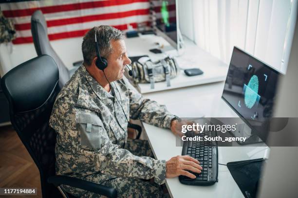 mature american soldier in headquarters office - intelligence agency stock pictures, royalty-free photos & images