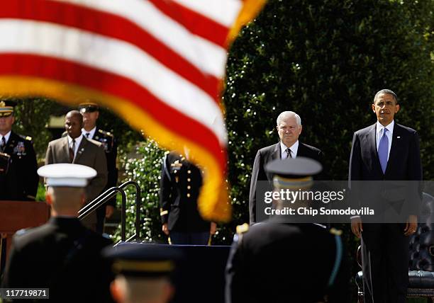 United States Secretary of Defense Robert Gates and President Barack Obama stand for the playing of the Star Spangled Banner during Gates' Armed...